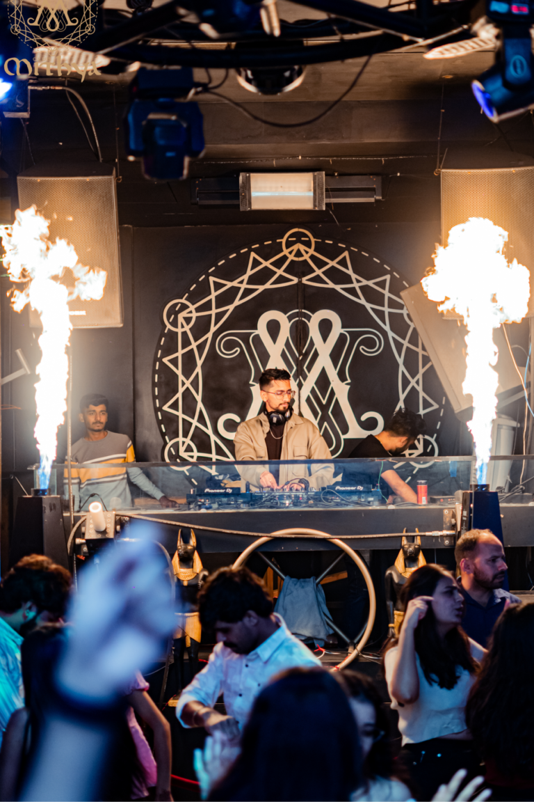 DJ Bloodshedder performing live at a high-energy club, Mithya.